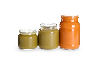 Jars with healthy baby food on white background