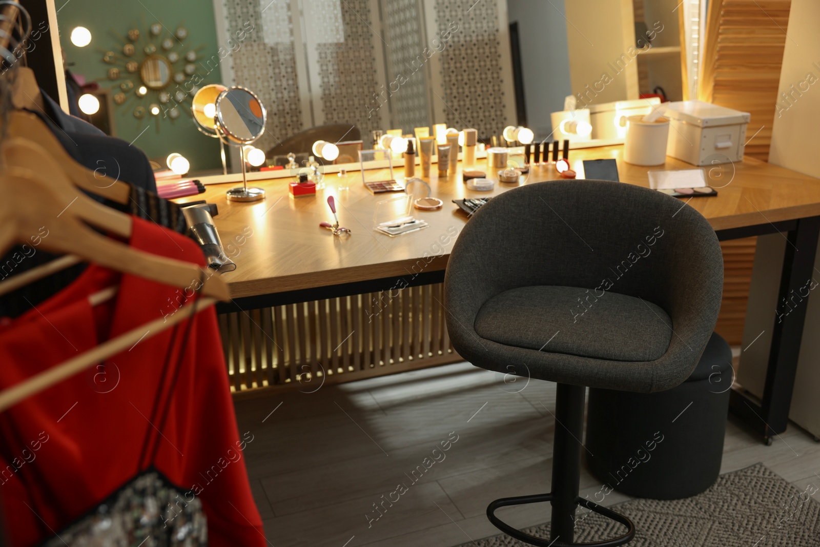 Photo of Makeup room. Chair near dressing table with different beauty products