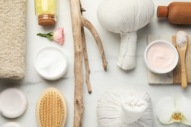 Flat lay composition with different spa products on white marble table