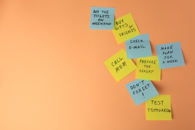 Photo of Many different reminder notes on pale orange background. Space for text