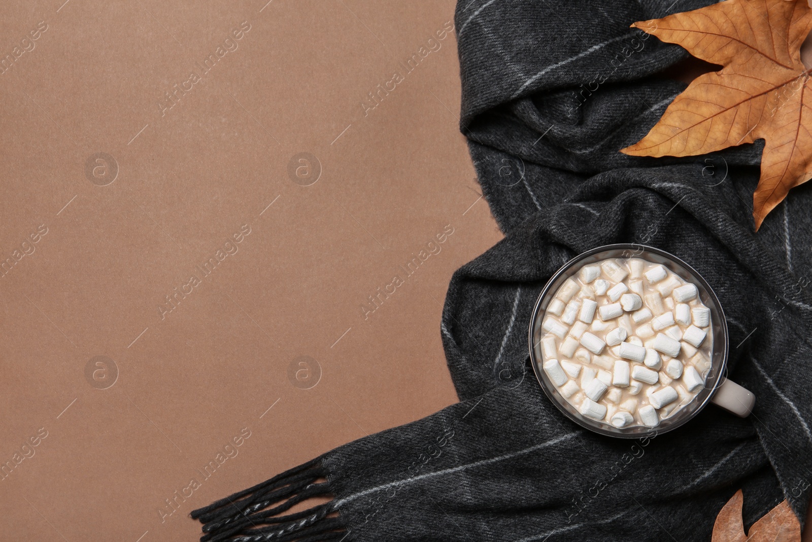 Photo of Flat lay composition with hot cozy drink and autumn leaves on color background. Space for text