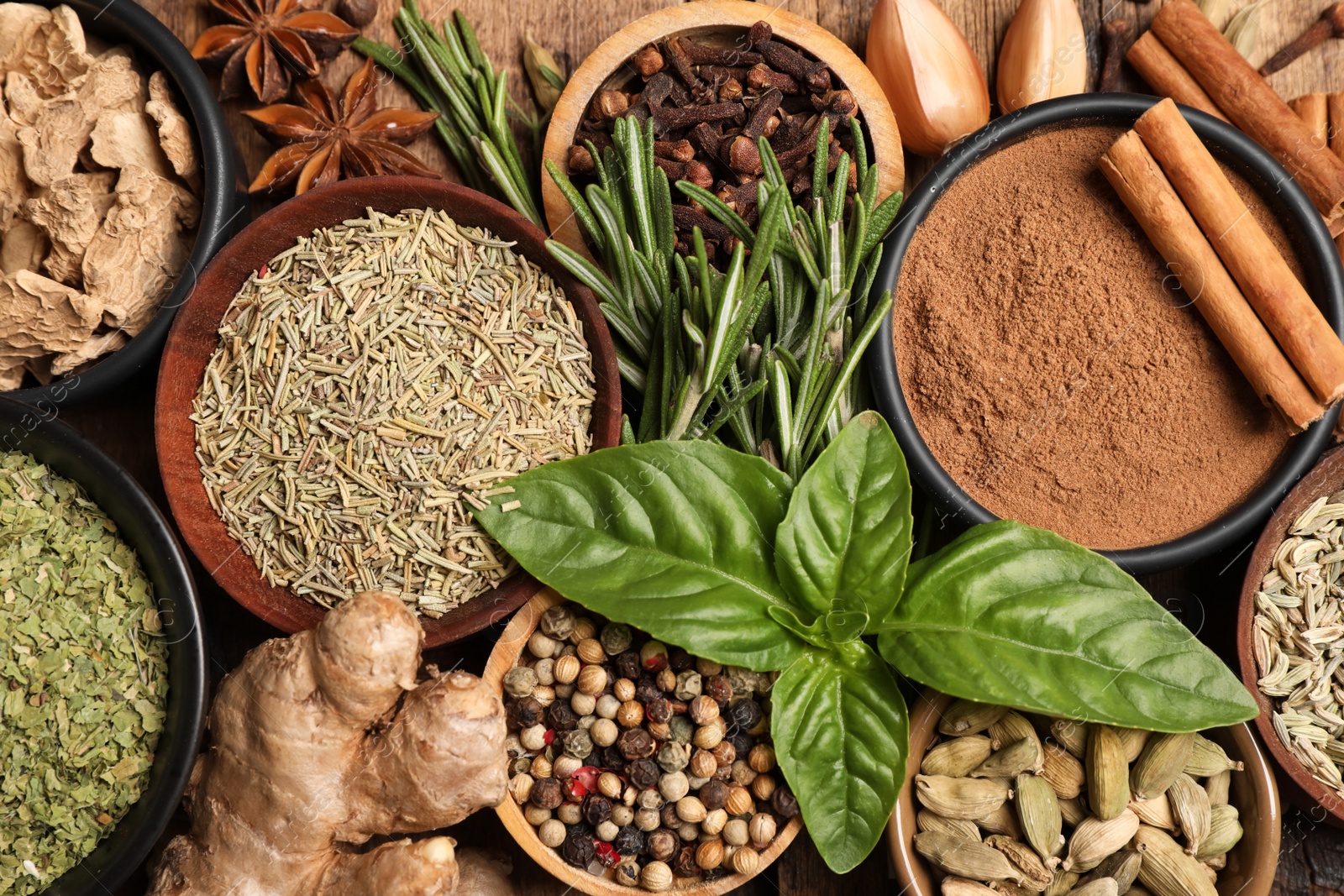 Photo of Flat lay composition with different natural spices and herbs on wooden table