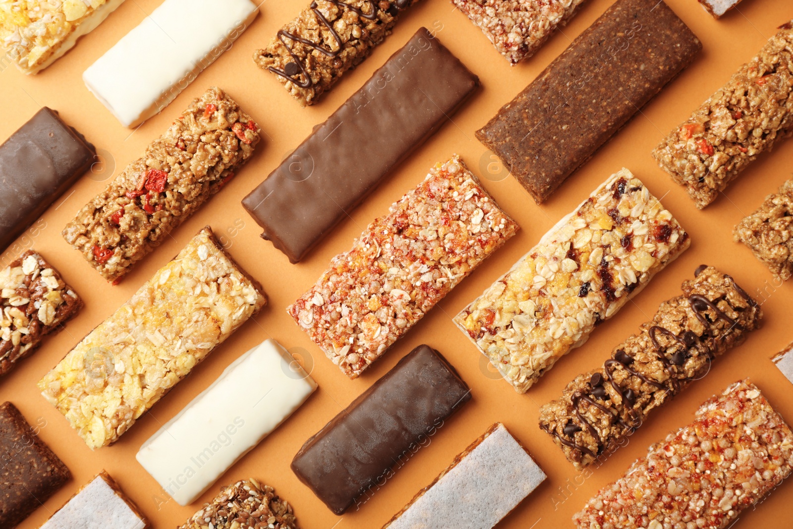 Photo of Flat lay composition with protein bars on color background