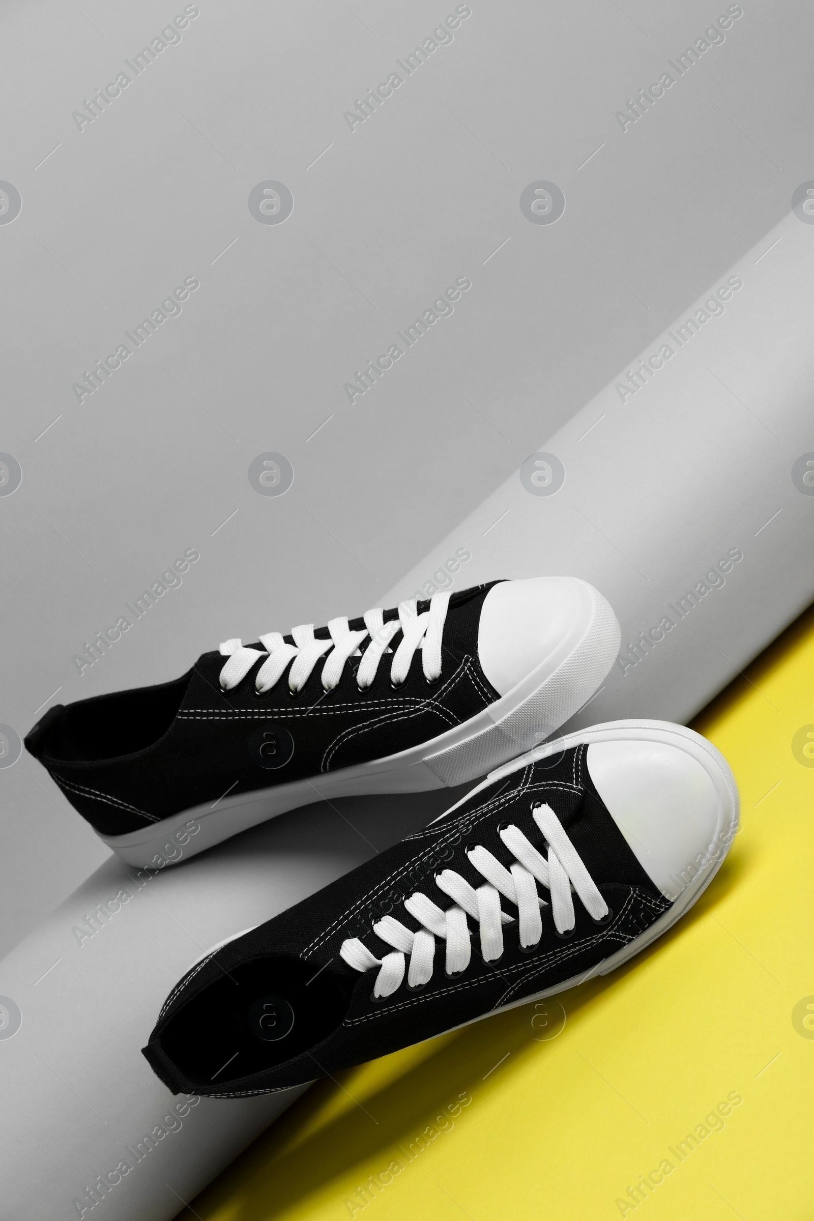 Photo of Pair of stylish sneakers on color background