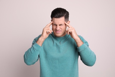 Portrait of stressed man on light background