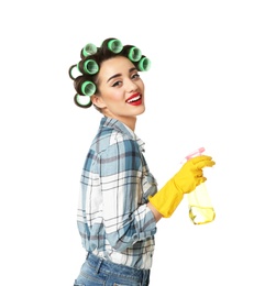 Photo of Funny young housewife with hair rollers holding detergent on white background