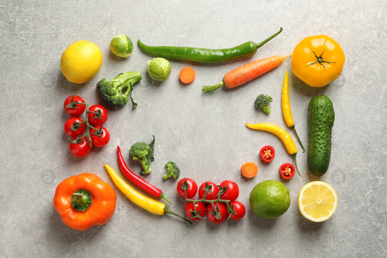 Photo of Flat lay composition with fresh vegetables and fruits on grey background