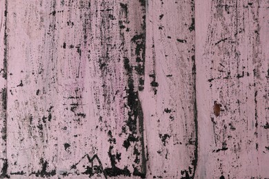 Photo of Old pink wooden surface with scratches as background, closeup