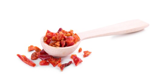 Photo of Aromatic spice. Red chili pepper flakes in spoon isolated on white