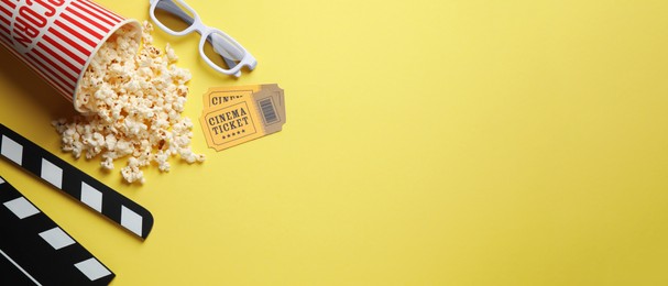 Image of Flat lay composition with delicious popcorn and glasses on yellow background, space for text. Banner design