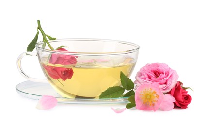 Photo of Aromatic herbal tea in glass cup and flowers isolated on white