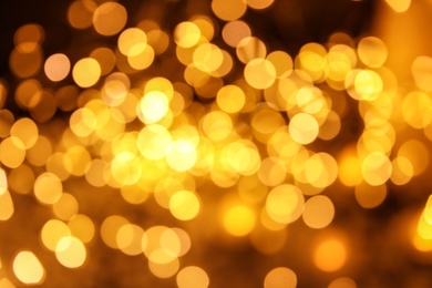 Photo of Gold glitter with bokeh effect on dark background