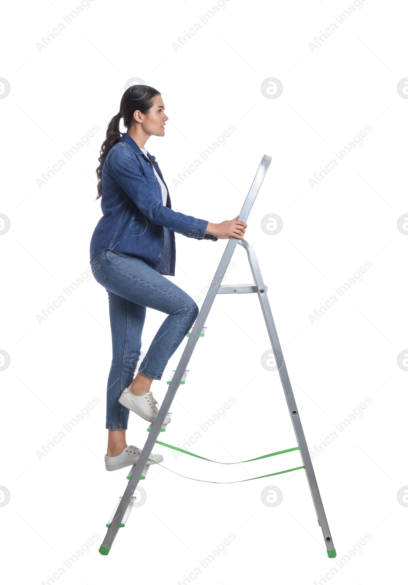 Photo of Young woman climbing up metal ladder on white background