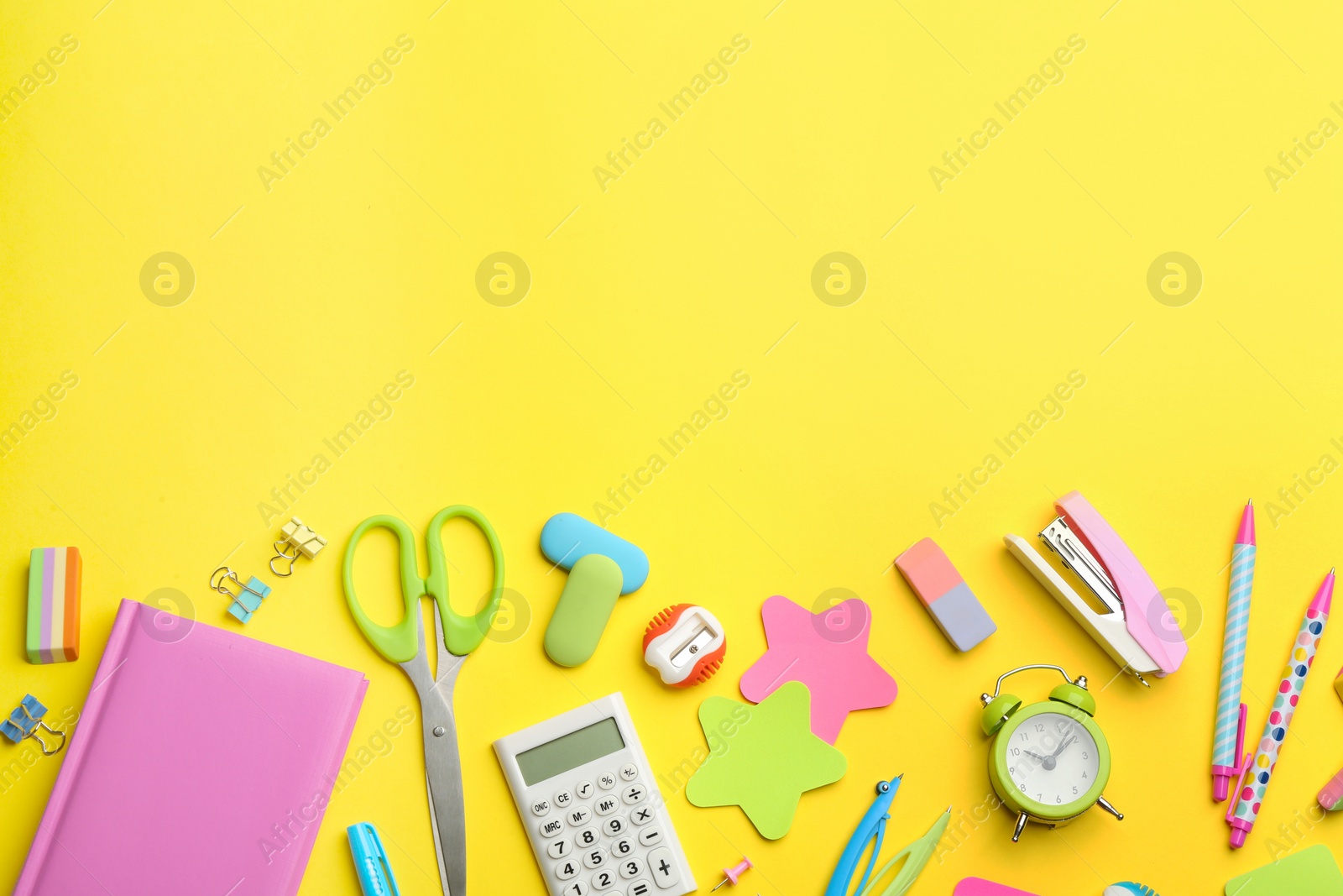 Photo of School stationery on yellow background, flat lay with space for text. Back to school