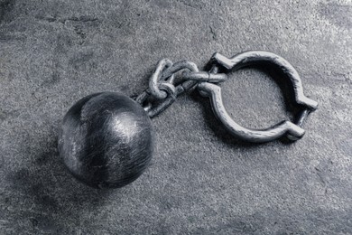 Photo of Prisoner ball with chain on grey table, top view