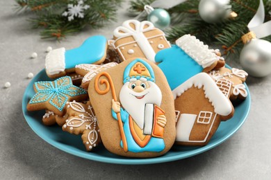 Photo of Tasty gingerbread cookies on light grey table, closeup. St. Nicholas Day celebration