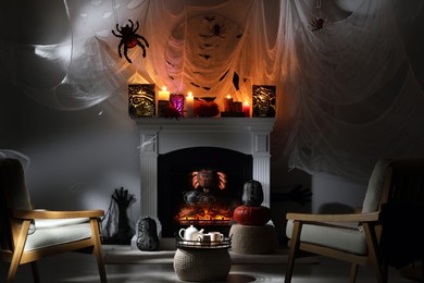 Room with fireplace decorated for Halloween. Festive interior
