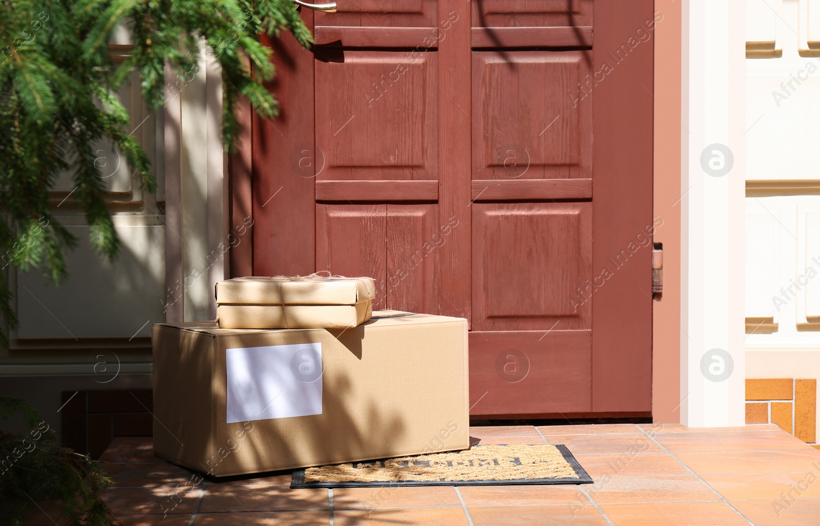 Photo of Delivered parcels on door mat near entrance