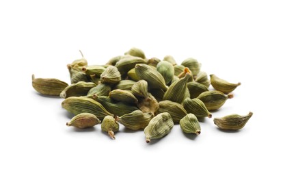 Pile of dry green cardamom pods on white background