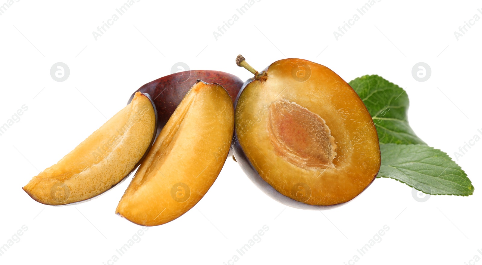 Photo of Cut ripe plums with green leaf isolated on white