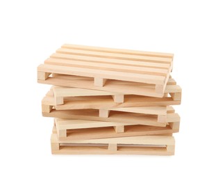 Photo of Stack of small wooden pallets on white background