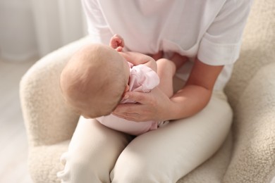 Photo of Mother with her cute little baby at home, closeup