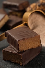 Tasty energy bar and protein powder on grey table, closeup