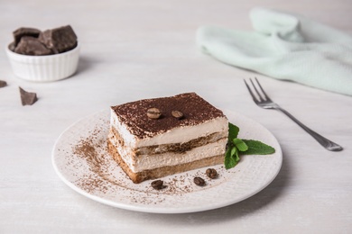 Photo of Tiramisu cake with coffee beans on table