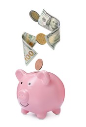 Image of Banknotes and coins falling into piggy bank on white background. Saving money