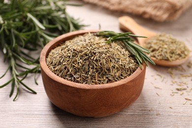 Photo of Bowl with dry and fresh rosemary on white wooden table, closeup