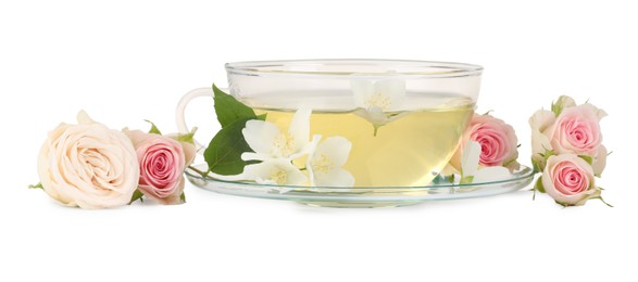 Aromatic herbal tea in glass cup and flowers isolated on white