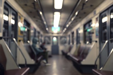 Photo of Blurred view of subway train interior with passengers. Public transport