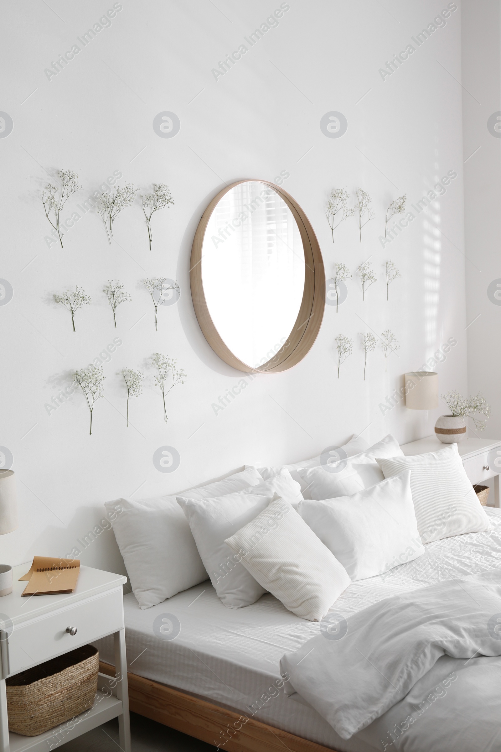 Photo of Modern bedroom interior with stylish round mirror