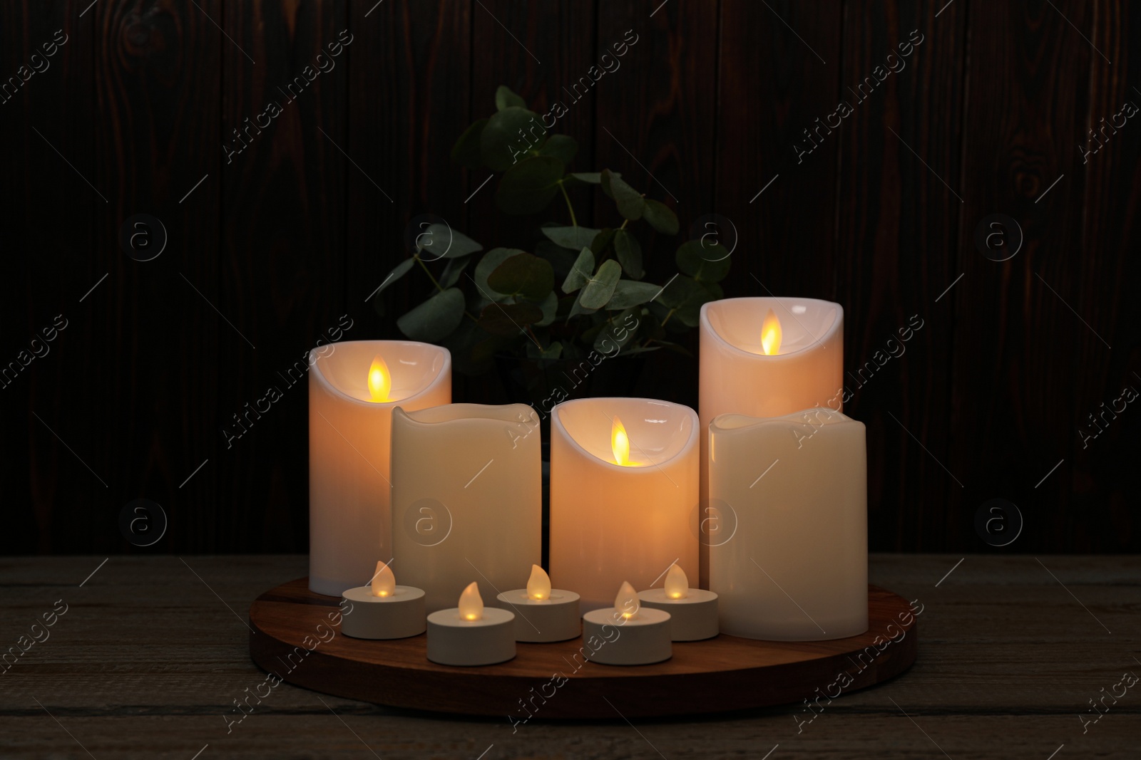 Photo of Beautiful decorative LED candles on wooden table