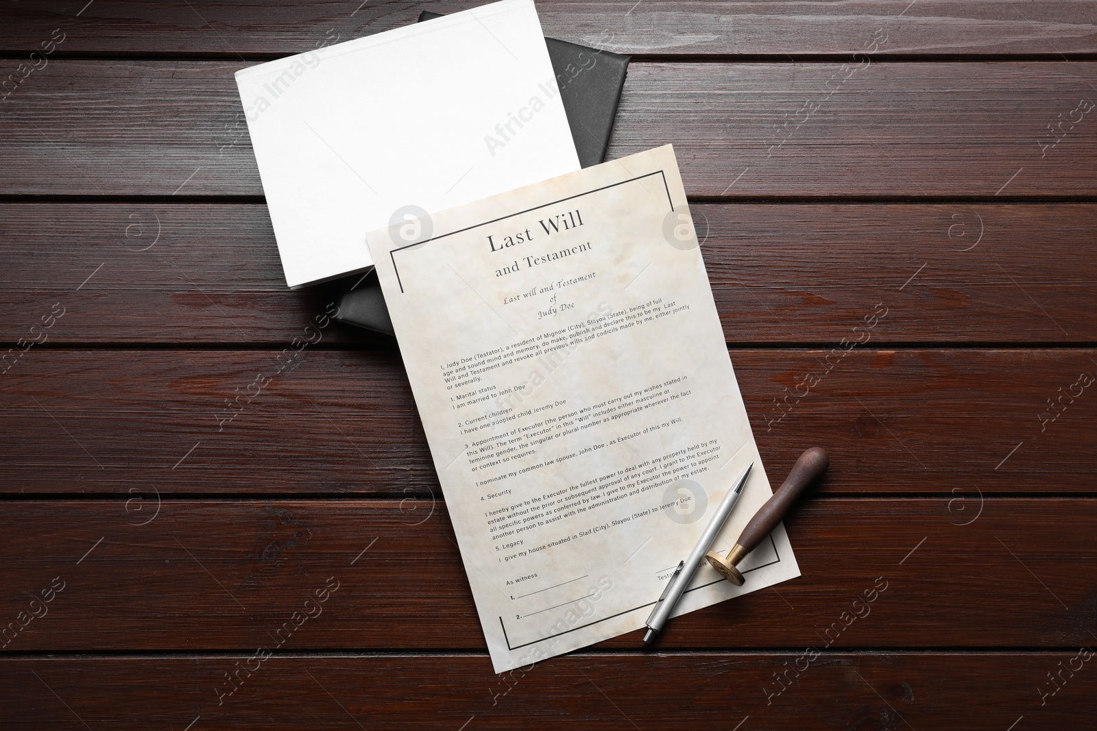 Photo of Last Will and Testament, books, stamp seal and pen on wooden table, flat lay