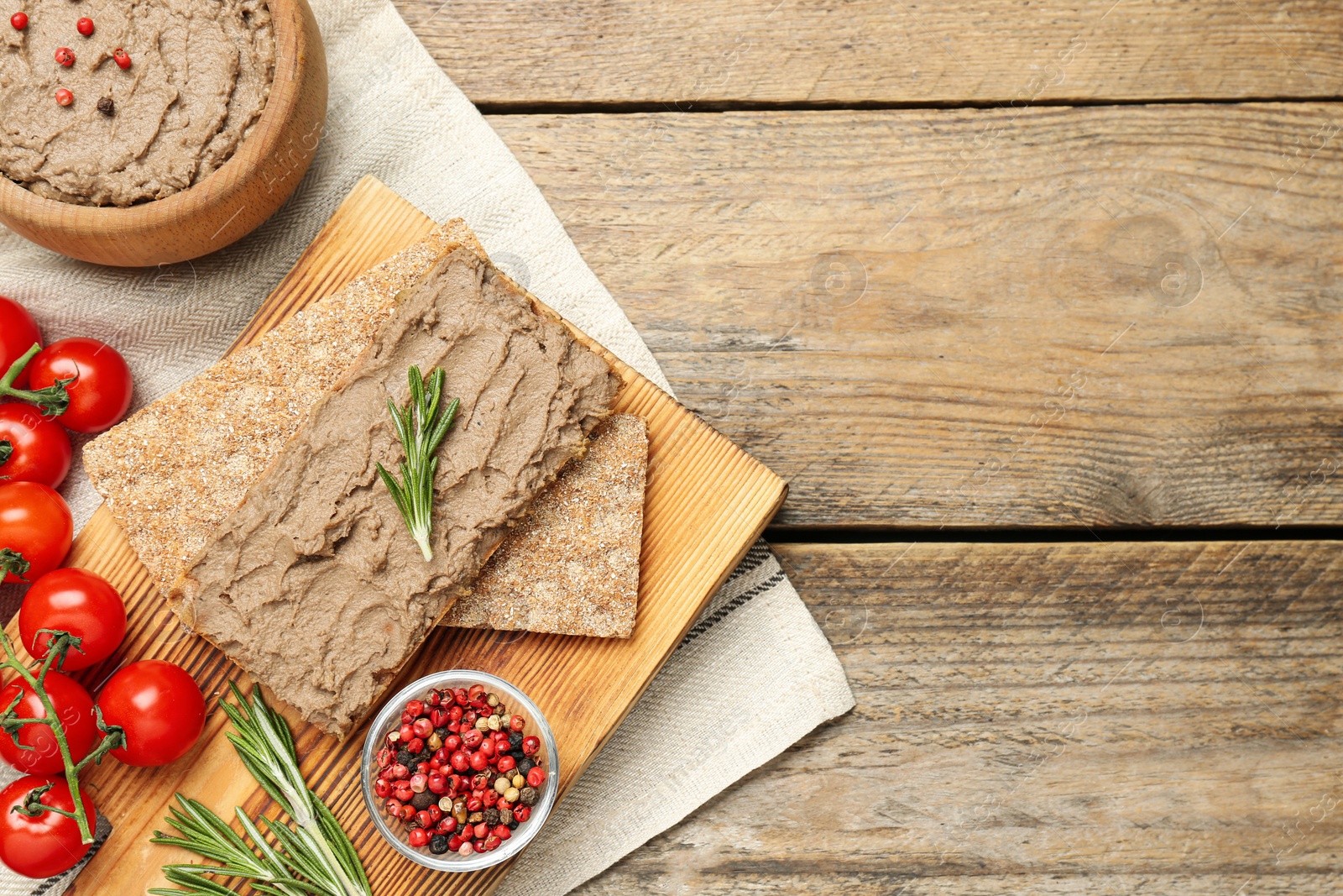 Photo of Flat lay composition with tasty liver pate on wooden table. Space for text