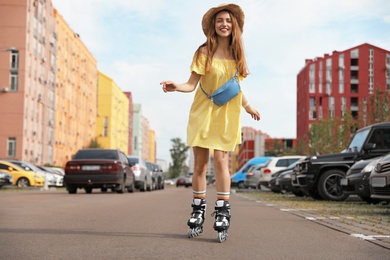 Beautiful young woman with roller skates having fun outdoors