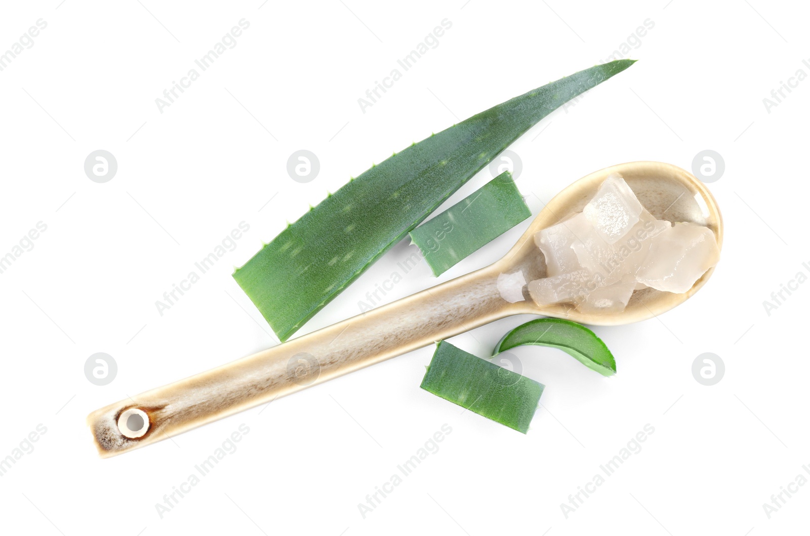 Photo of Spoon with peeled aloe vera and pieces of green plant isolated on white, top view