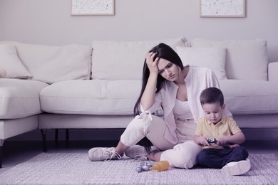 Depressed single mother with child at home, color toned