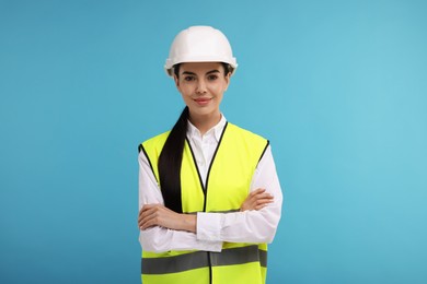 Photo of Engineer in hard hat on light blue background