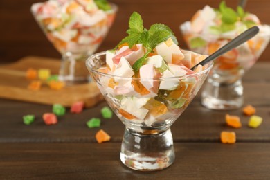 Delicious broken glass jelly dessert on wooden table