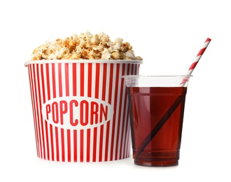 Photo of Bucket with delicious popcorn and plastic cup of cola on white background