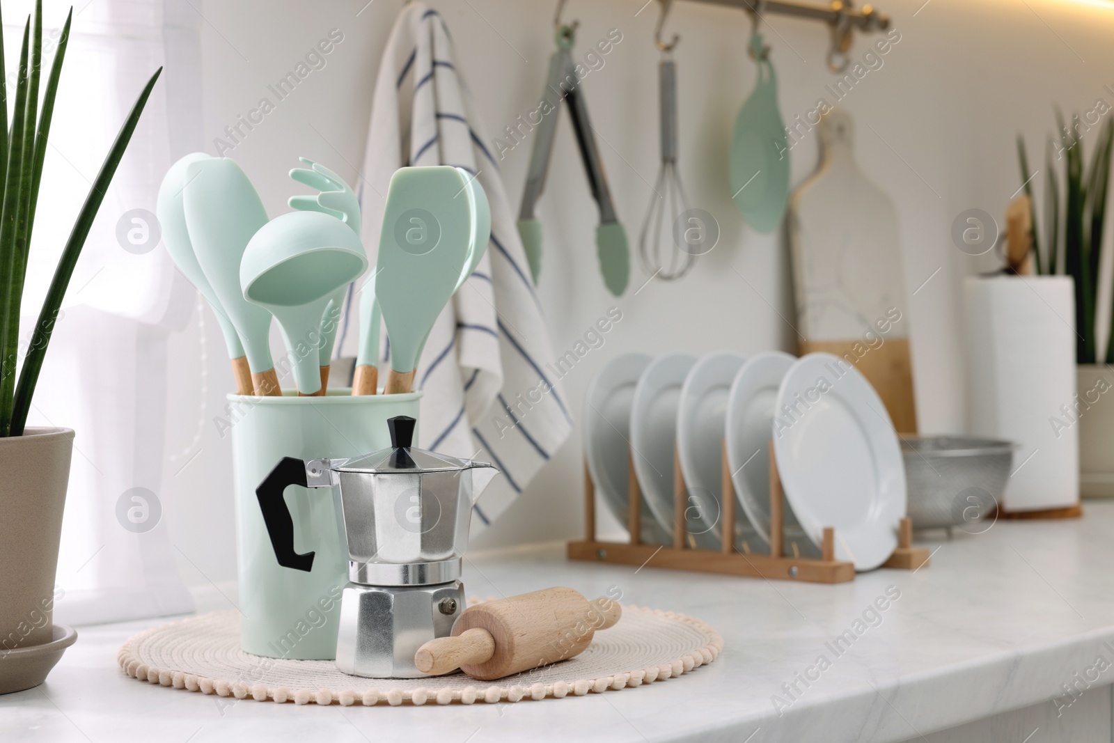 Photo of Set of different utensils and dishes on countertop in kitchen