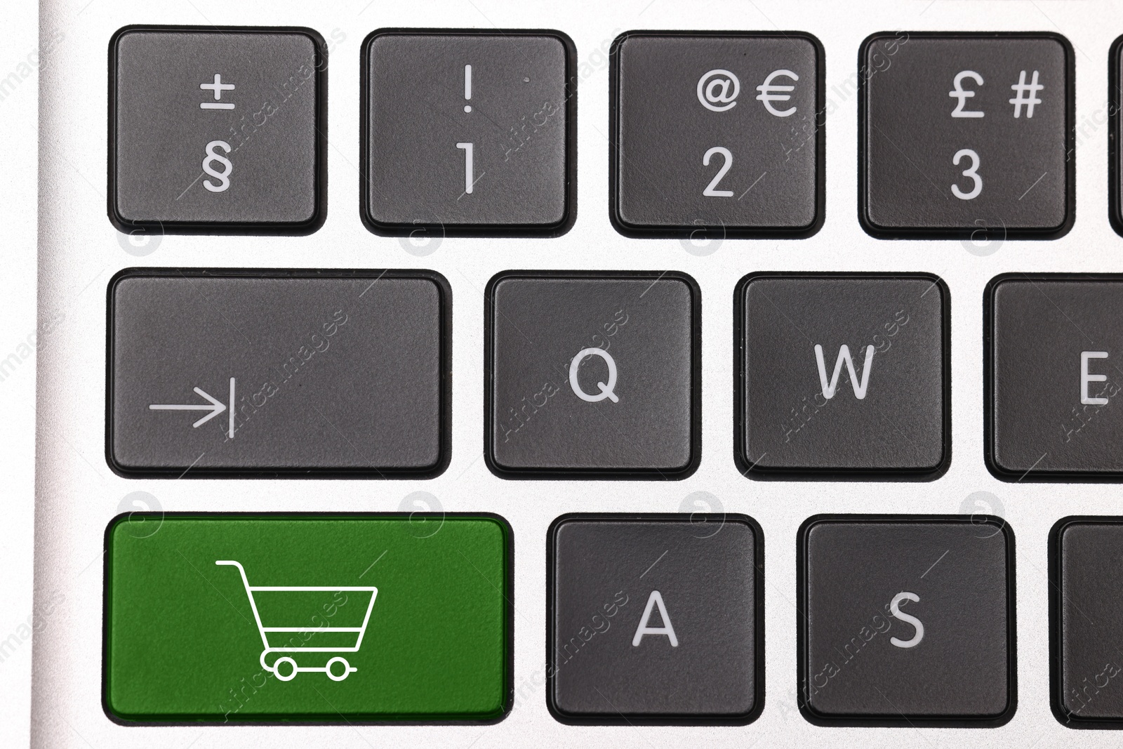 Image of Internet store. Green button with shopping cart on computer keyboard, top view