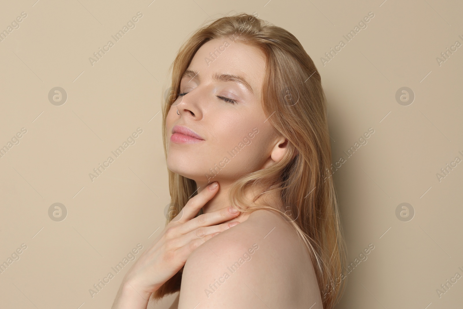 Photo of Portrait of beautiful young woman on beige background