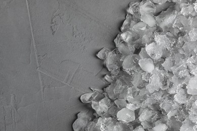 Photo of Heap of crushed ice on grey table, top view. Space for text