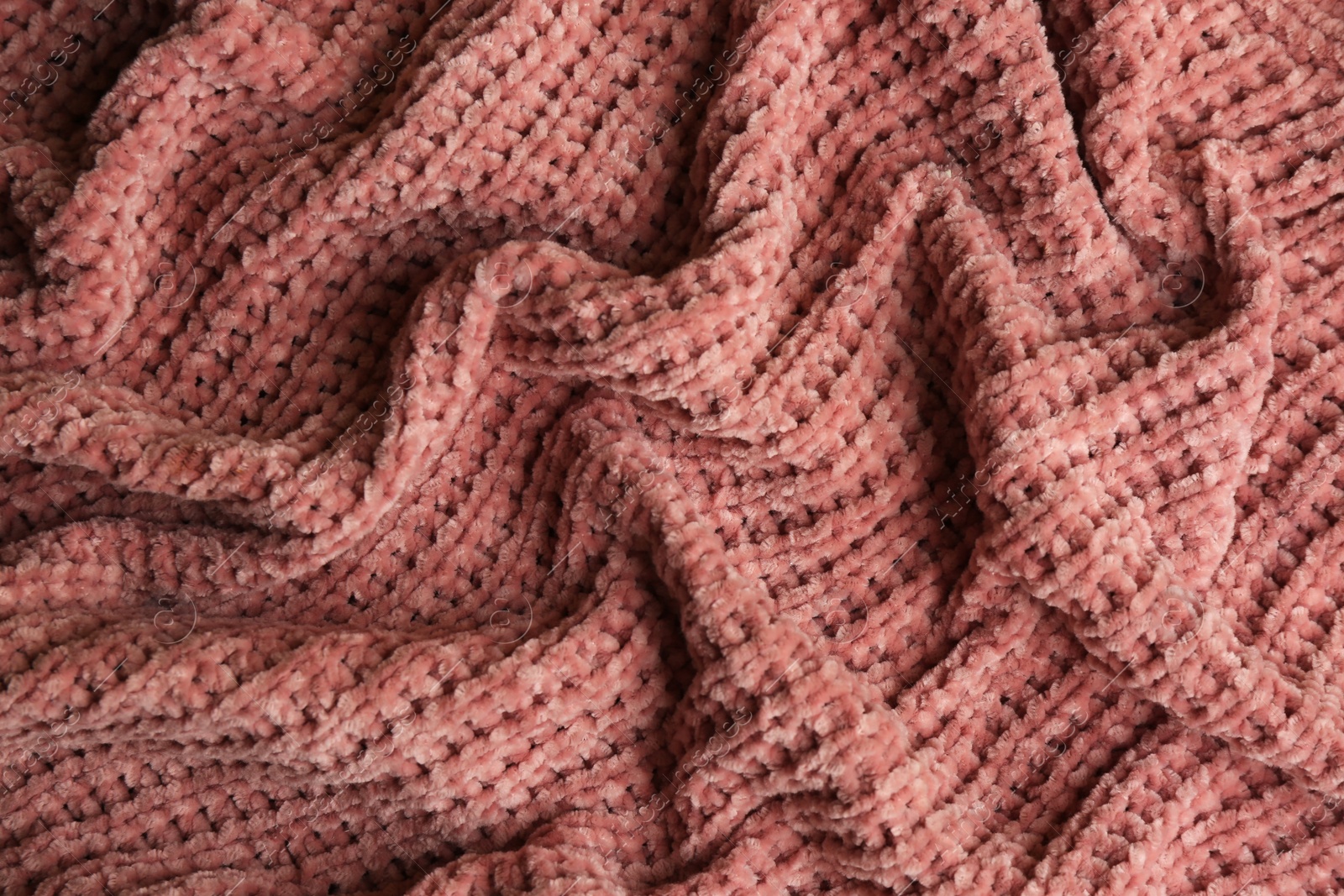 Photo of Beautiful pink knitted fabric as background, top view