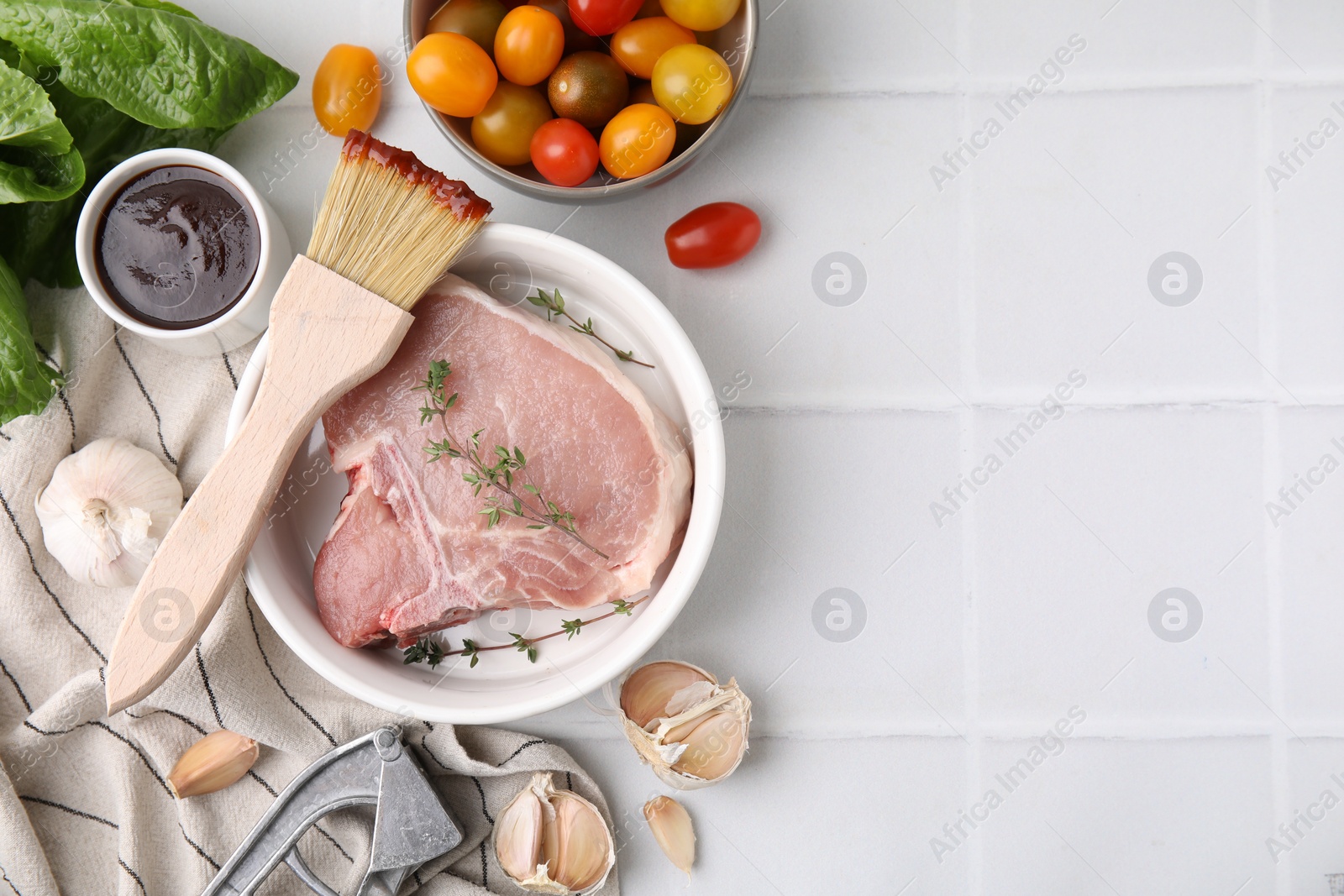 Photo of Flat lay composition with raw meat, thyme and marinade on white tiled table. Space for text