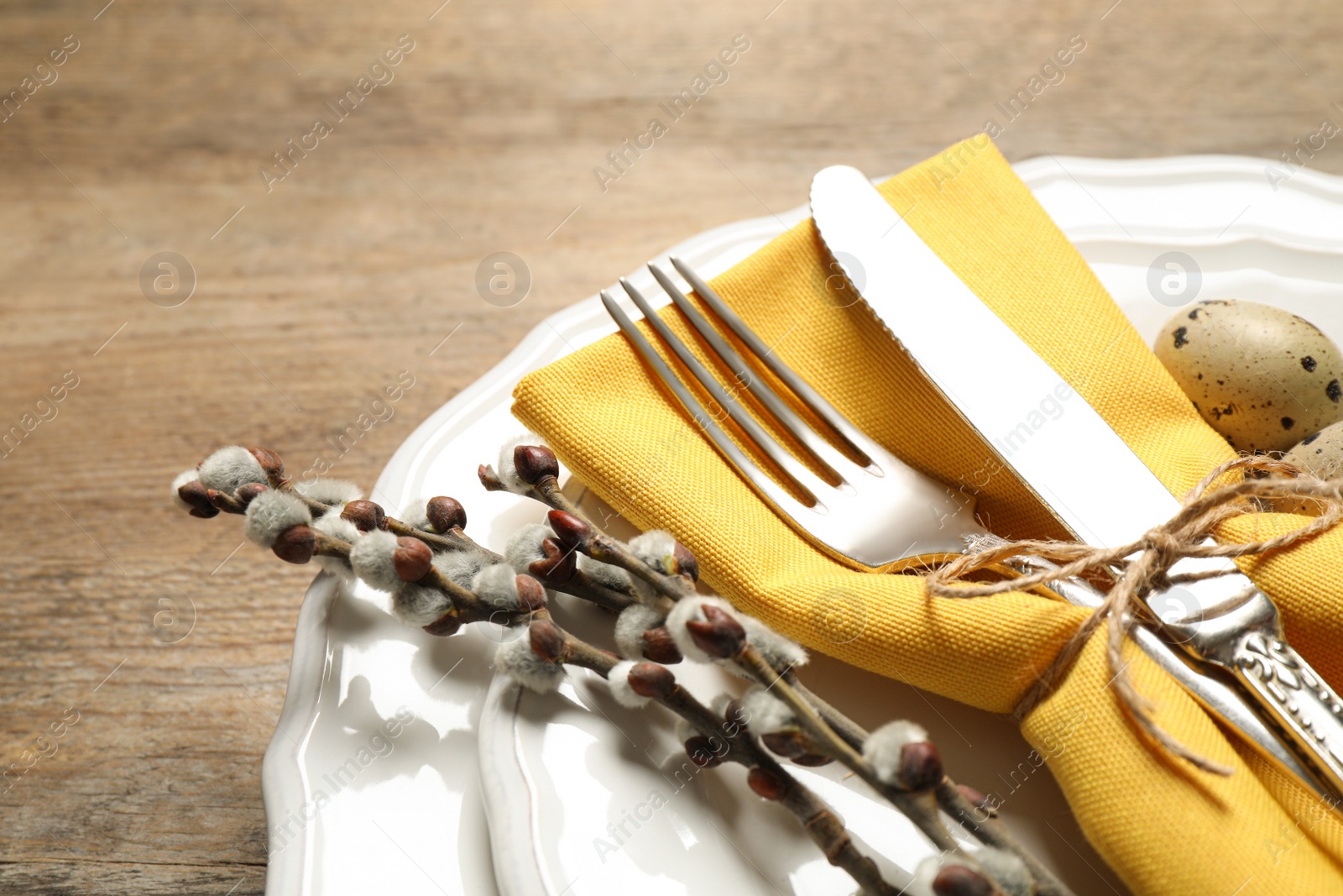 Photo of Festive Easter table setting with beautiful willow branches, closeup