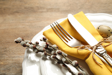 Photo of Festive Easter table setting with beautiful willow branches, closeup